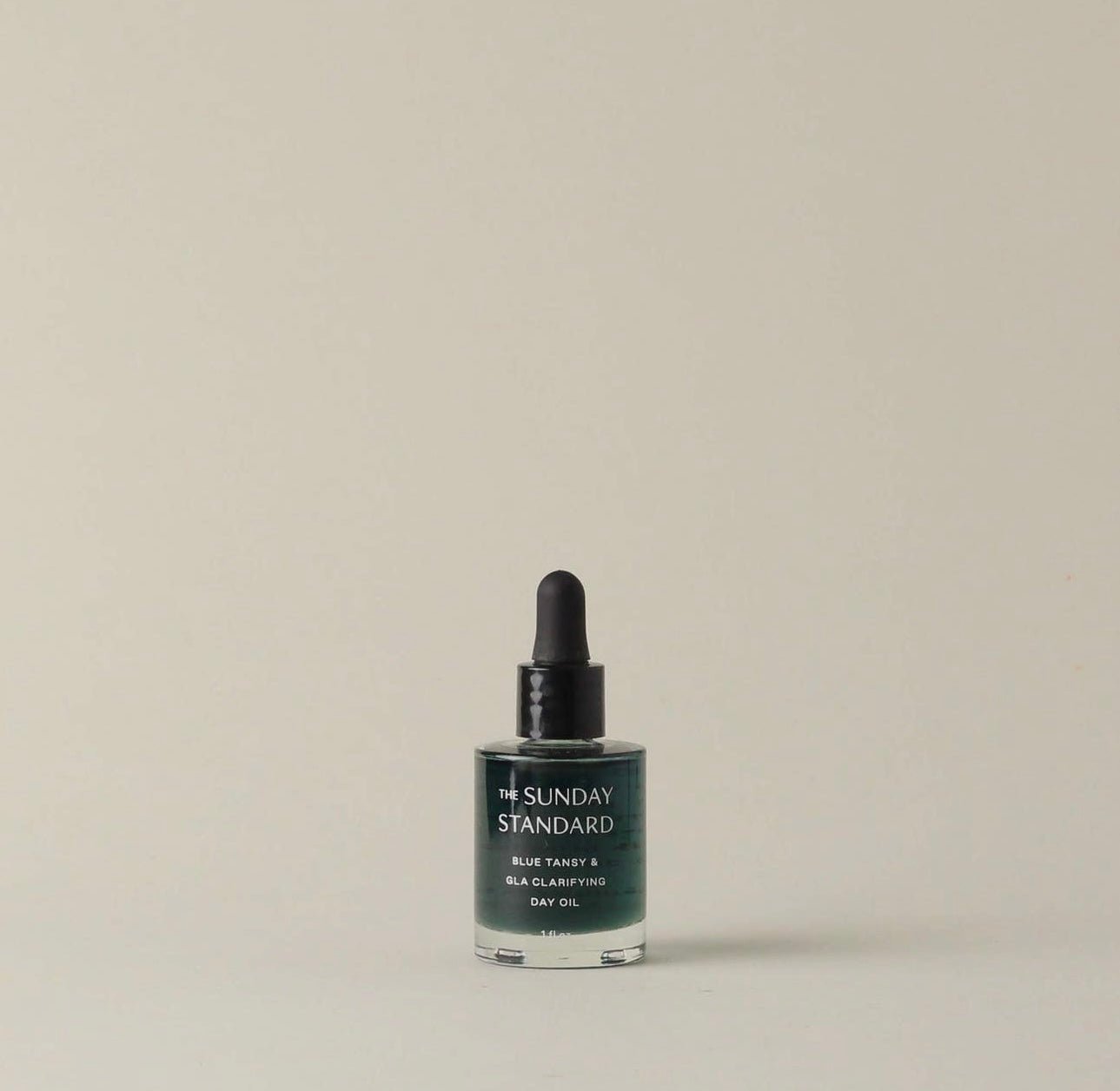 The Sunday Standard Blue Tansy & GLA Clarifying Day Oil in a glass dropper bottle on a neutral background.