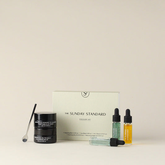 Full Sunday Standard Discovery Set including facial oils, mask jars, a spatula, serum, oils and branded box, arranged neatly on a neutral background.