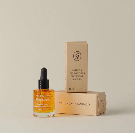 The Sunday Standard Rosehip & Sea Buckthorn Restorative Night Oil with two packaging boxes, displayed on a neutral background.