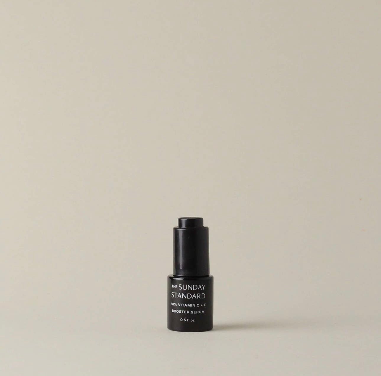 A single bottle of The Sunday Standard Brightening 18% Vitamin C and E Booster Serum on a neutral background.