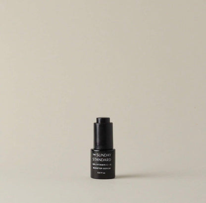 A single bottle of The Sunday Standard Brightening 18% Vitamin C and E Booster Serum on a neutral background.
