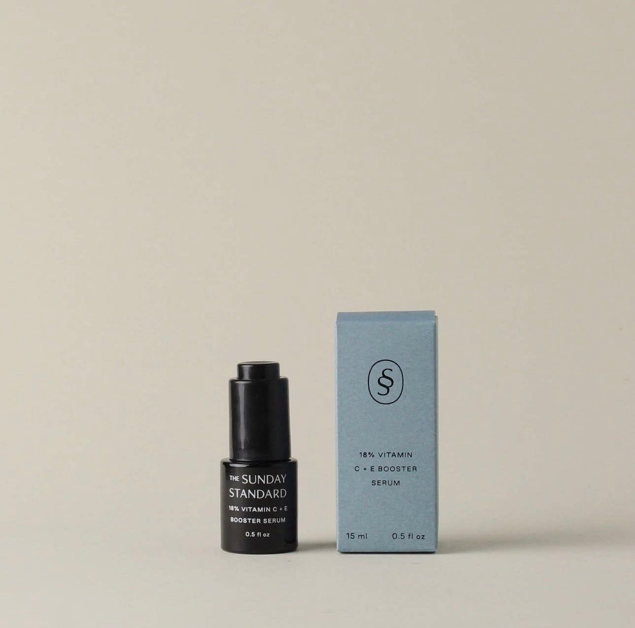 The Sunday Standard Brightening Vitamin C and E Booster Serum bottle next to its upright product box.