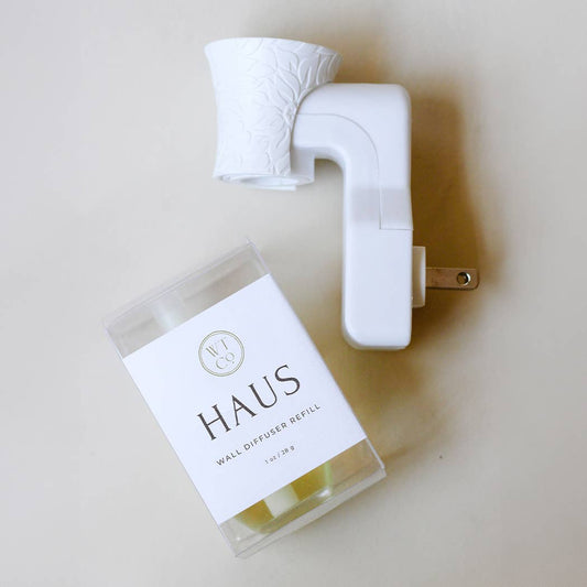 Well-Taylored Haus Wall Diffuser Refill with a white wall plug in unit on neutral background.