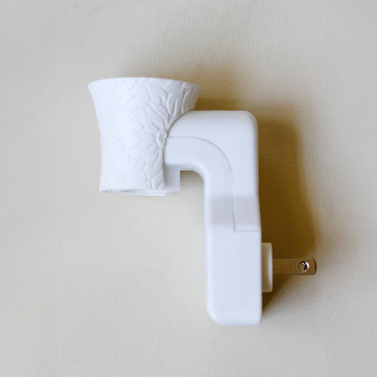 Well-Taylored Wall Diffuser Plug-In shown unplugged on neutral background in white.